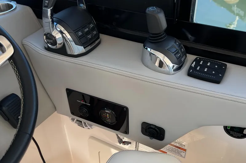 Y Knot Yacht Photos Pics Control panel of 2021 Regal 36 Grande Coupe boat with joystick and throttle controls.