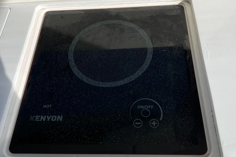 Y Knot Yacht Photos Pics Ceramic cooktop on 2021 Regal 36 Grande Coupe yacht, featuring Kenyon controls.