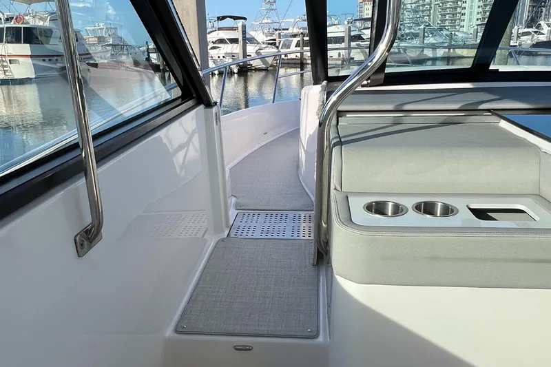 Y Knot Yacht Photos Pics 2021 Regal 36 Grande Coupe interior with sleek design and marina view.