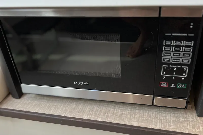 Y Knot Yacht Photos Pics Muave microwave oven with digital controls in a modern kitchen setting.