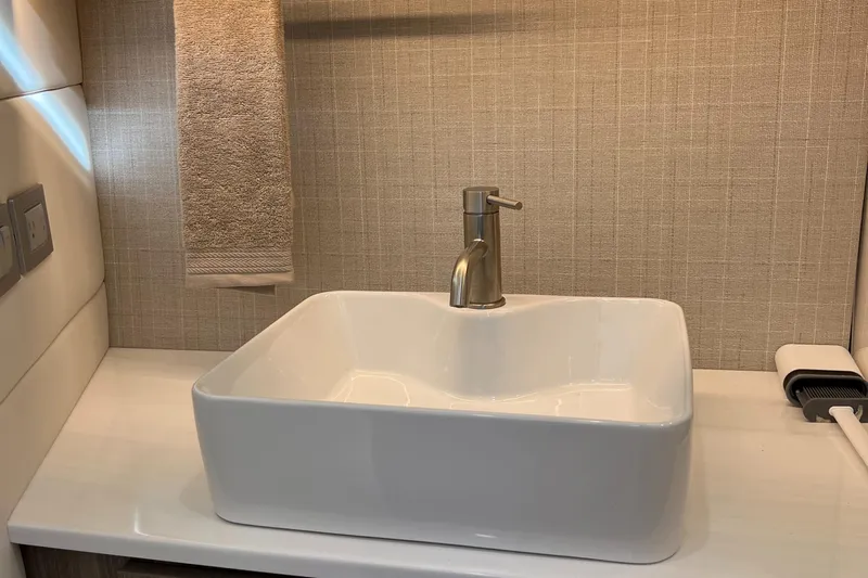 Y Knot Yacht Photos Pics Modern bathroom sink with a sleek faucet in a 2021 Regal 36 Grande Coupe.