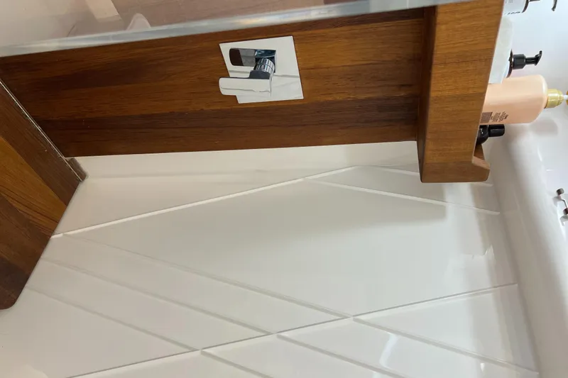 Y Knot Yacht Photos Pics Interior detail of 2021 Regal 36 Grande Coupe, featuring wood paneling and modern fixtures.