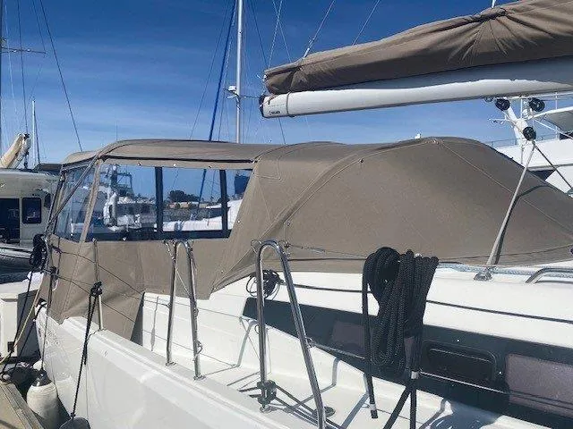 Pearl Yacht Photos Pics 2023 Jeanneau 380 sailboat with tan canopy docked at marina.