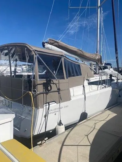 Pearl Yacht Photos Pics 2023 Jeanneau 380 sailboat docked, featuring a covered cockpit and sleek design.