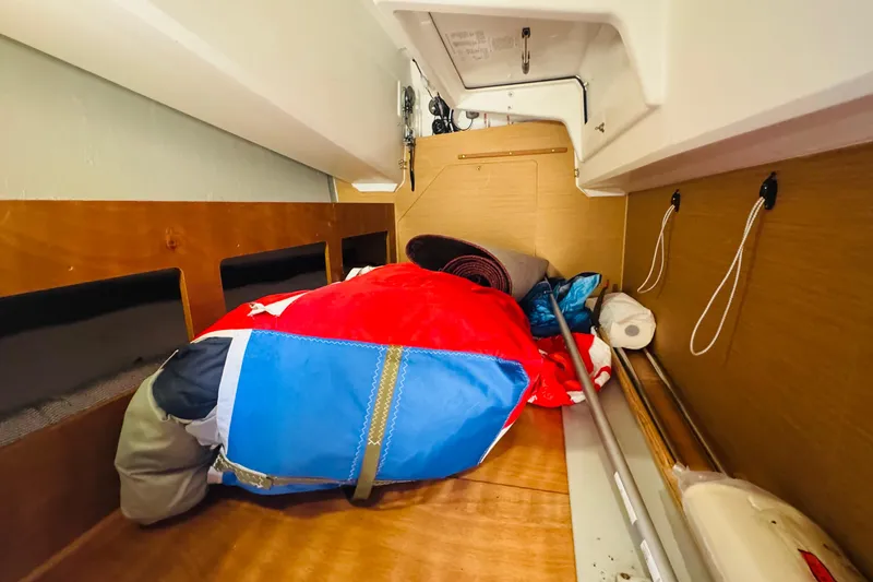Pearl Yacht Photos Pics Interior storage space of 2023 Jeanneau 380 sailboat with colorful gear and equipment.