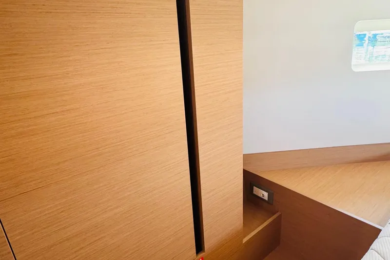 Pearl Yacht Photos Pics 2023 Jeanneau 380 interior with wooden finish and small window.