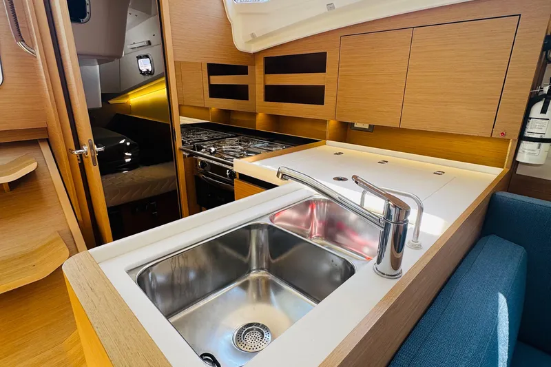 Pearl Yacht Photos Pics Modern kitchen interior of 2023 Jeanneau 380 yacht with sink and stove.