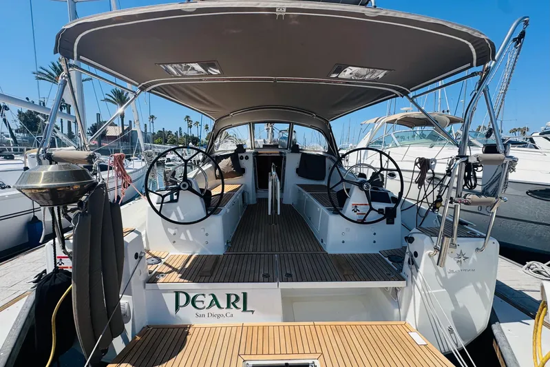 Pearl Yacht Photos Pics 2023 Jeanneau 380 sailboat docked in San Diego marina, featuring dual steering wheels.