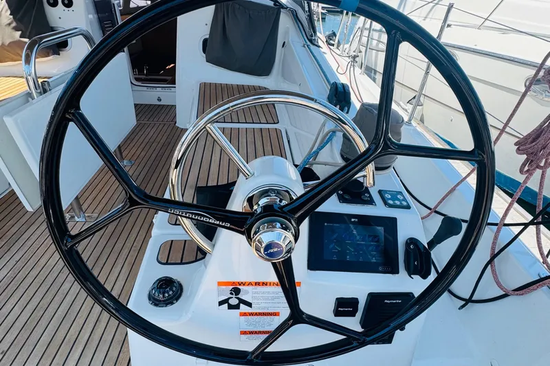 Pearl Yacht Photos Pics Steering wheel and controls of 2023 Jeanneau 380 sailboat, featuring modern navigation equipment.