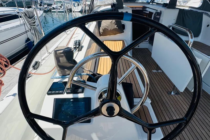 Pearl Yacht Photos Pics Steering wheel of 2023 Jeanneau 380 sailboat, docked at marina.