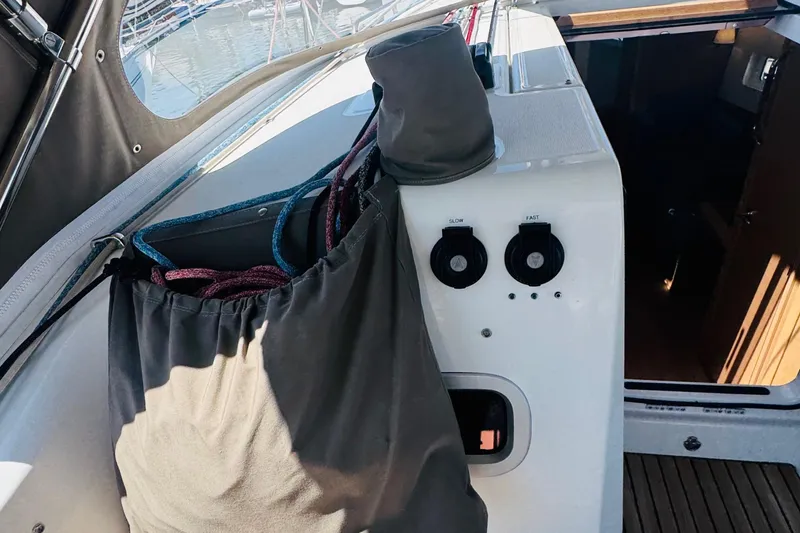 Pearl Yacht Photos Pics 2023 Jeanneau 380 yacht cockpit with control panel and rope storage.