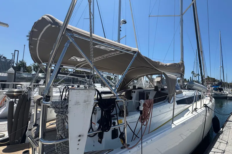 Pearl Yacht Photos Pics 2023 Jeanneau 380 sailboat docked at marina, featuring a sleek design and sunshade canopy.