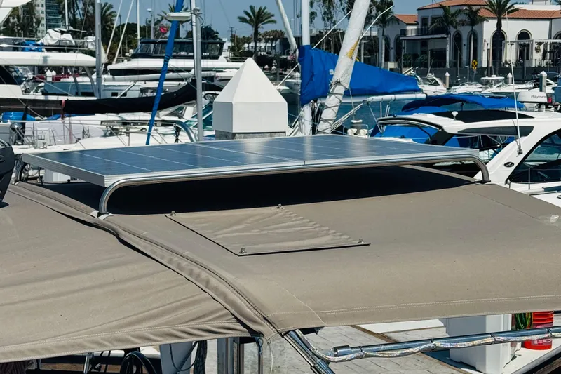 Pearl Yacht Photos Pics 2023 Jeanneau 380 yacht with solar panel, docked in a marina.