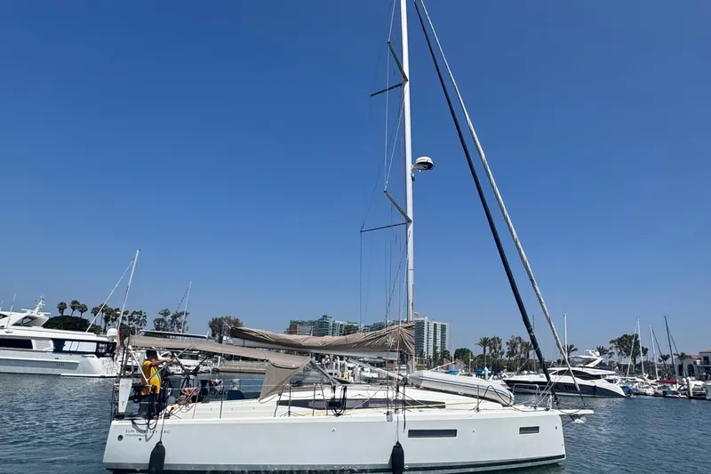 Pearl Yacht Photos Pics 2023 Jeanneau 380 sailboat docked in a marina under clear blue skies.