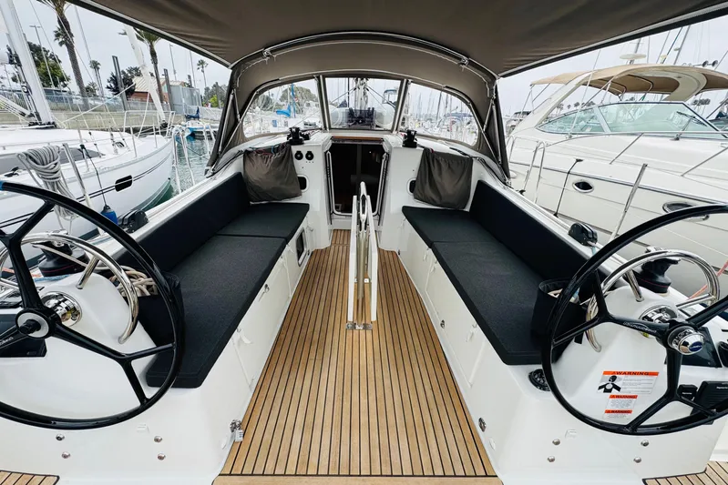 Pearl Yacht Photos Pics 2023 Jeanneau 380 sailboat cockpit with dual steering wheels and teak flooring.