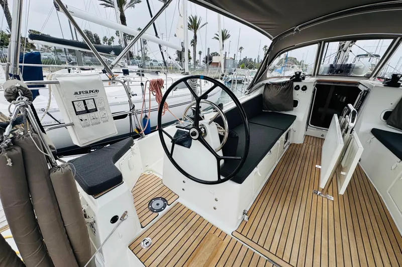 Pearl Yacht Photos Pics 2023 Jeanneau 380 yacht cockpit with steering wheel and teak flooring.