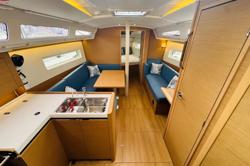 Pearl Yacht Photos Pics Interior of 2023 Jeanneau 380 yacht, featuring modern kitchen and cozy seating area.