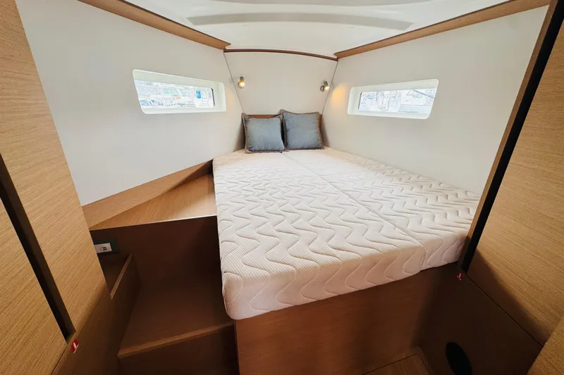 Pearl Yacht Photos Pics Luxurious cabin interior of 2023 Jeanneau 380 yacht with cozy bed and modern design.