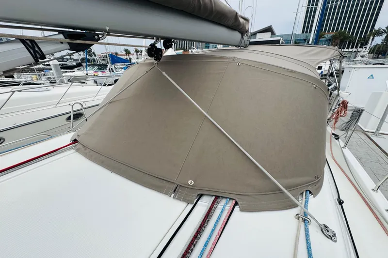 Pearl Yacht Photos Pics 2023 Jeanneau 380 sailboat with beige canvas cover at marina.