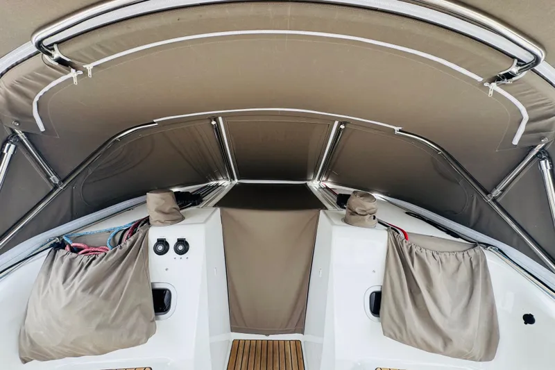 Pearl Yacht Photos Pics 2023 Jeanneau 380 sailboat cockpit with protective canopy and covered equipment.
