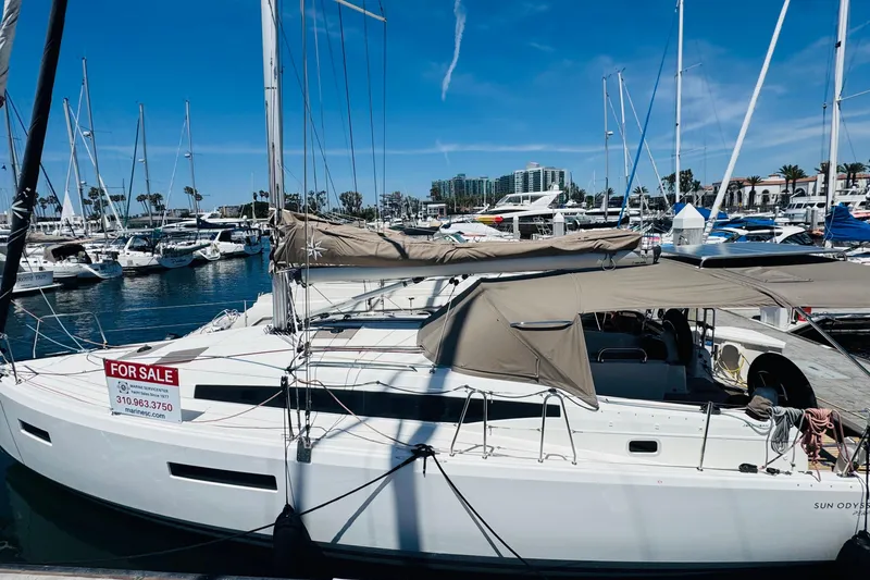 Pearl Yacht Photos Pics 2023 Jeanneau 380 sailboat for sale at marina, clear blue sky background.