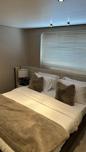 Sunlife Yacht Photos Pics Luxurious bedroom in 2024 Azimut Grande 27 METRI yacht with plush bedding and modern decor.