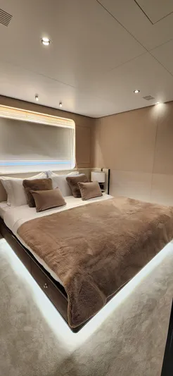 Sunlife Yacht Photos Pics Luxurious bedroom in 2024 Azimut Grande 27 METRI yacht, featuring elegant bedding and ambient lighting.