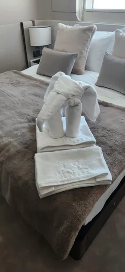 Sunlife Yacht Photos Pics Luxurious bedroom in 2024 Azimut Grande 27 METRI yacht with towel elephant decor.
