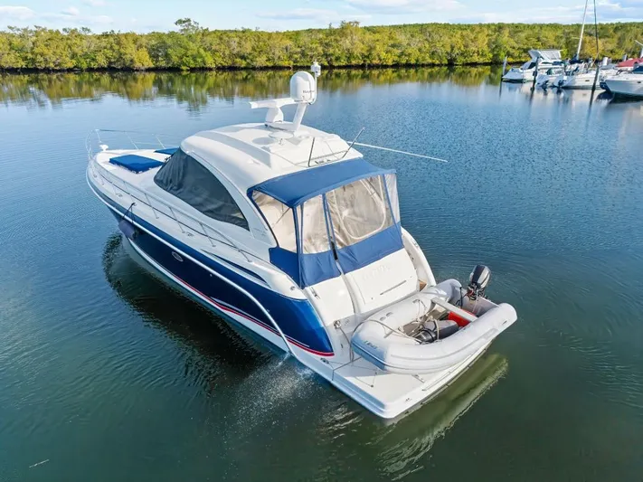 Hermes3 Yacht Photos Pics 2007 Formula 45 Yacht cruising on calm waters with inflatable boat attached.