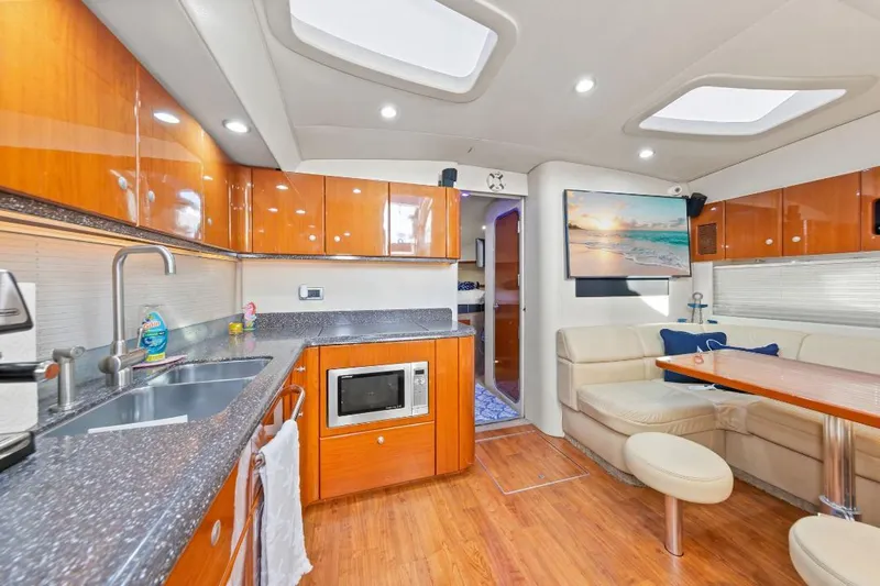 Hermes3 Yacht Photos Pics Luxurious interior of a 2007 Formula 45 Yacht with modern kitchen and seating area.