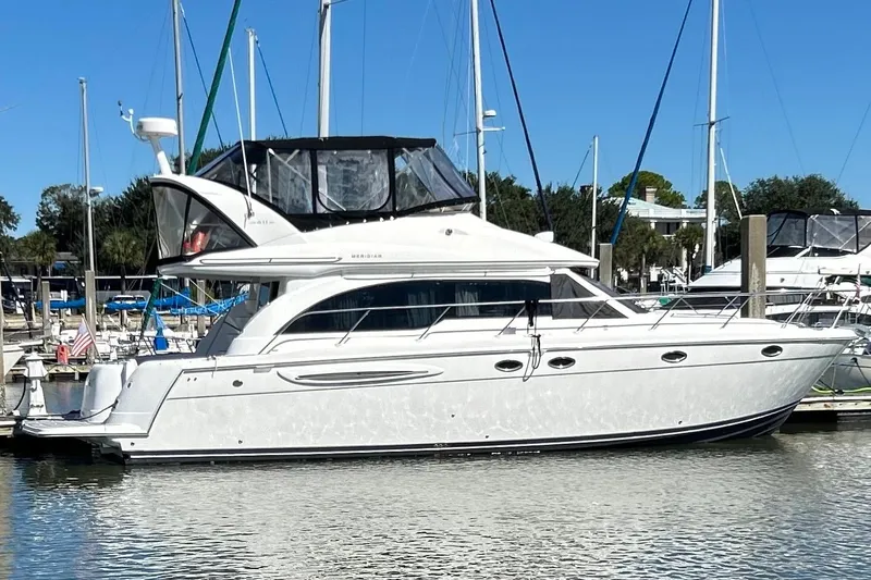 Miss Louise II Yacht Photos Pics 2007 Meridian 411SB yacht docked in a marina under clear blue skies.