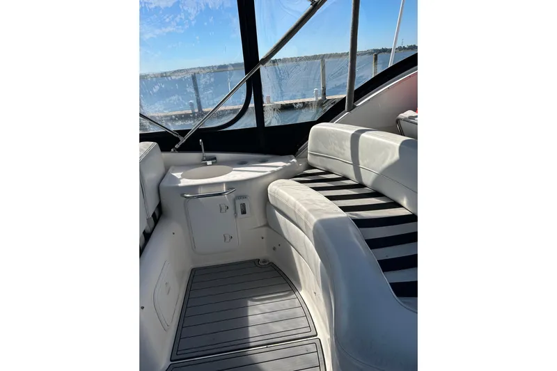 Miss Louise II Yacht Photos Pics Interior of 2007 Meridian 411SB yacht with white seating and striped cushions.