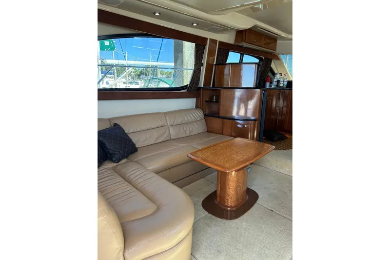 Miss Louise II Yacht Photos Pics Luxurious interior of 2007 Meridian 411SB yacht with leather seating and wooden table.