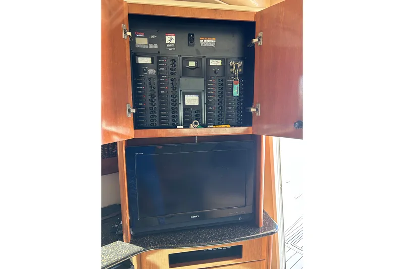 Miss Louise II Yacht Photos Pics Electrical panel and TV in 2007 Meridian 411SB yacht interior.
