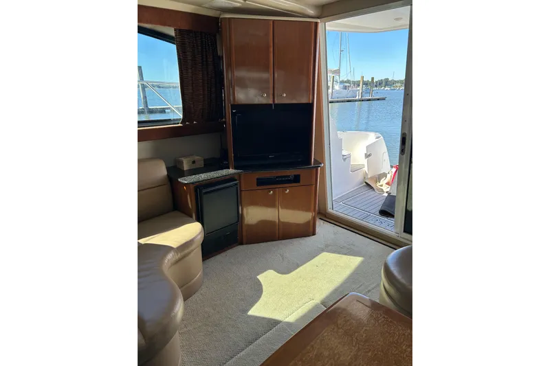 Miss Louise II Yacht Photos Pics Interior of 2007 Meridian 411SB yacht with TV, seating, and open deck view.