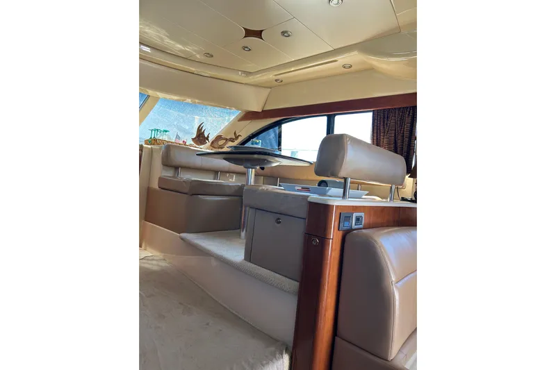 Miss Louise II Yacht Photos Pics Luxurious interior of 2007 Meridian 411SB yacht with beige leather seating and elegant design.