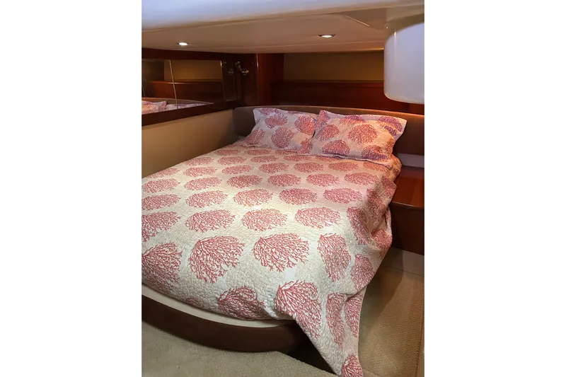 Miss Louise II Yacht Photos Pics Cozy bedroom in 2007 Meridian 411SB yacht with coral-patterned bedding.