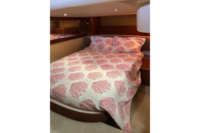 Miss Louise II Yacht Photos Pics Cozy bedroom in 2007 Meridian 411SB yacht with coral-patterned bedding.