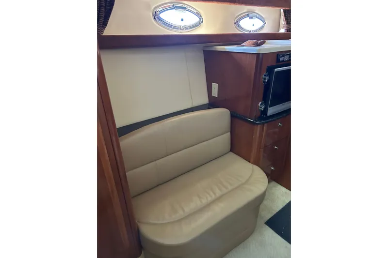 Miss Louise II Yacht Photos Pics 2007 Meridian 411SB yacht interior with beige leather seating and built-in microwave.
