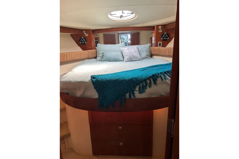 Miss Louise II Yacht Photos Pics Luxurious bedroom interior of 2007 Meridian 411SB yacht with cozy bedding and elegant wood finish.