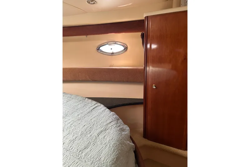 Miss Louise II Yacht Photos Pics 2007 Meridian 411SB yacht interior with wood paneling and porthole window.