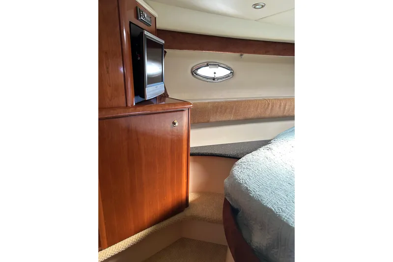 Miss Louise II Yacht Photos Pics Interior of 2007 Meridian 411SB yacht with wood cabinetry and small window.