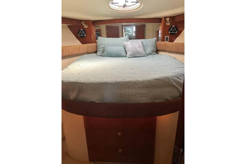 Miss Louise II Yacht Photos Pics Cozy bedroom interior of 2007 Meridian 411SB yacht with elegant bedding and wood accents.