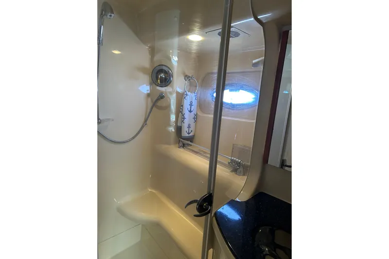 Miss Louise II Yacht Photos Pics Luxurious bathroom in 2007 Meridian 411SB yacht with shower and nautical decor.