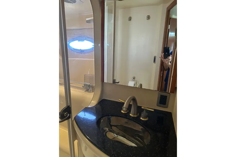 Miss Louise II Yacht Photos Pics Luxurious bathroom in 2007 Meridian 411SB yacht with sleek black countertop.