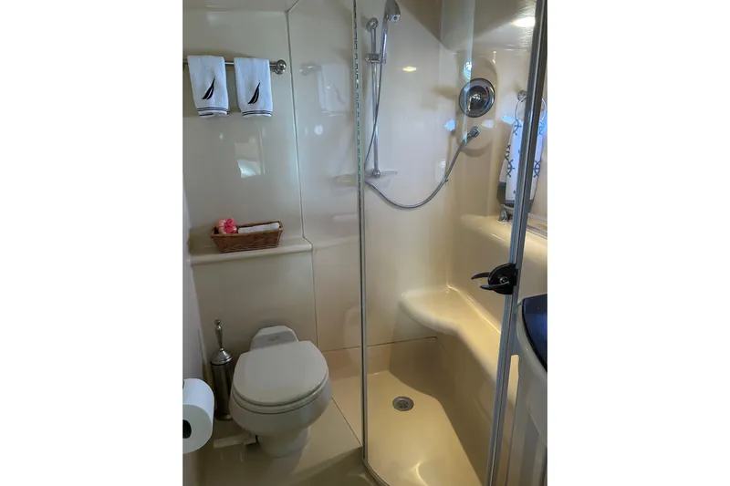 Miss Louise II Yacht Photos Pics Compact bathroom in 2007 Meridian 411SB yacht with shower, toilet, and towel rack.