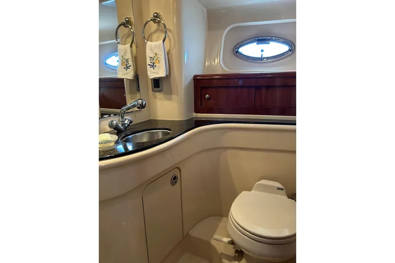 Miss Louise II Yacht Photos Pics Luxurious bathroom in 2007 Meridian 411SB yacht with sink, toilet, and porthole window.