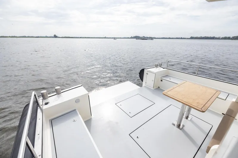 Wild Thing Yacht Photos Pics Explorer NG 50 Alu Fast Going 2016 boat deck with table, overlooking calm waters.