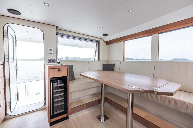 Wild Thing Yacht Photos Pics Luxurious interior of 2016 Explorer NG 50 Alu Fast Going yacht with elegant seating and table.