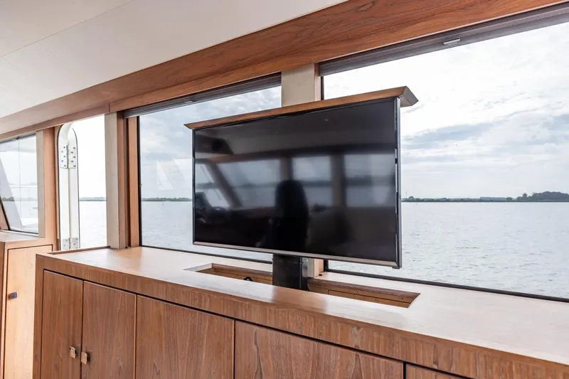 Wild Thing Yacht Photos Pics Luxurious interior of 2016 Explorer NG 50 yacht with retractable TV and scenic water view.